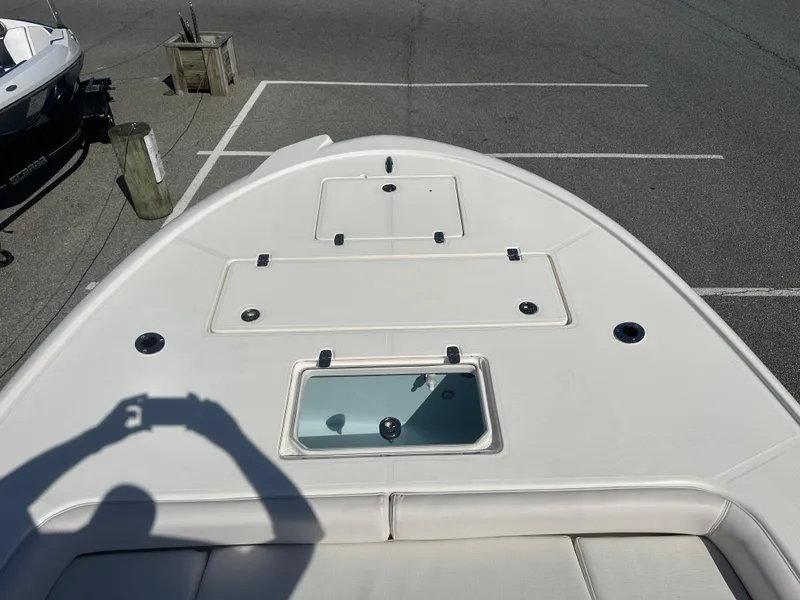 Slide: The Image of 2024 Sea Born FX25 Bay boat deck with storage compartments and livewell. - 13
