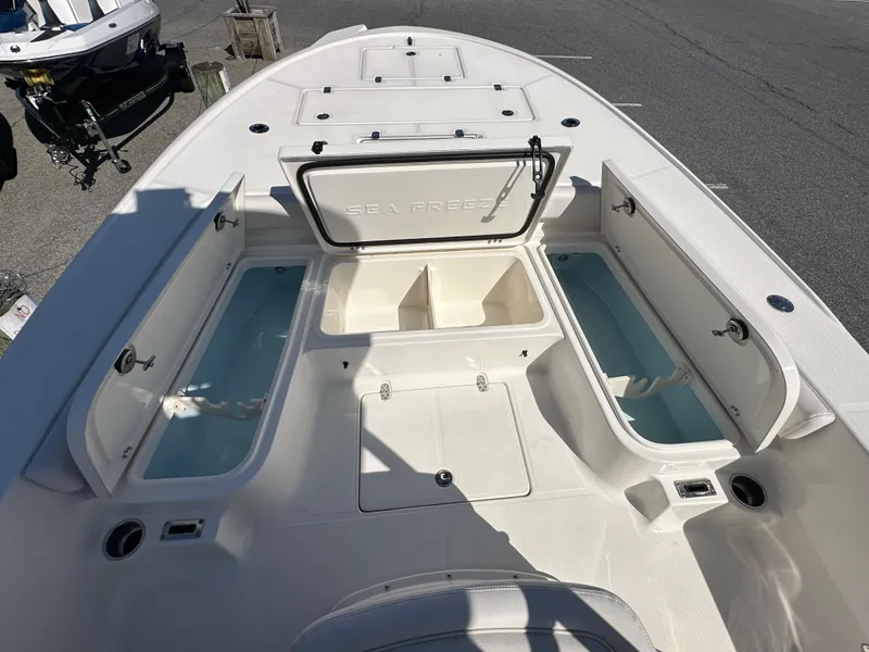 Slide: The Image of 2024 Sea Born FX25 Bay boat with open storage compartments. - 15