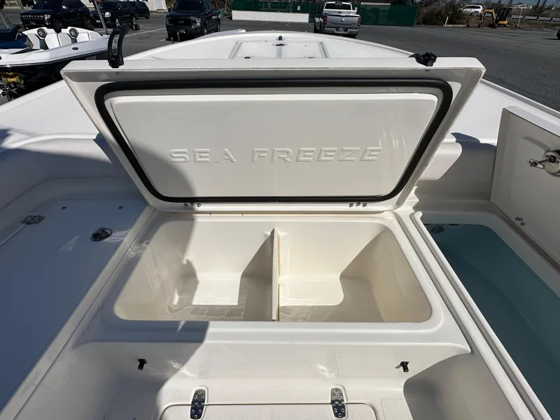 Slide: The Image of 2024 Sea Born FX25 Bay boat with open storage compartments. - 17