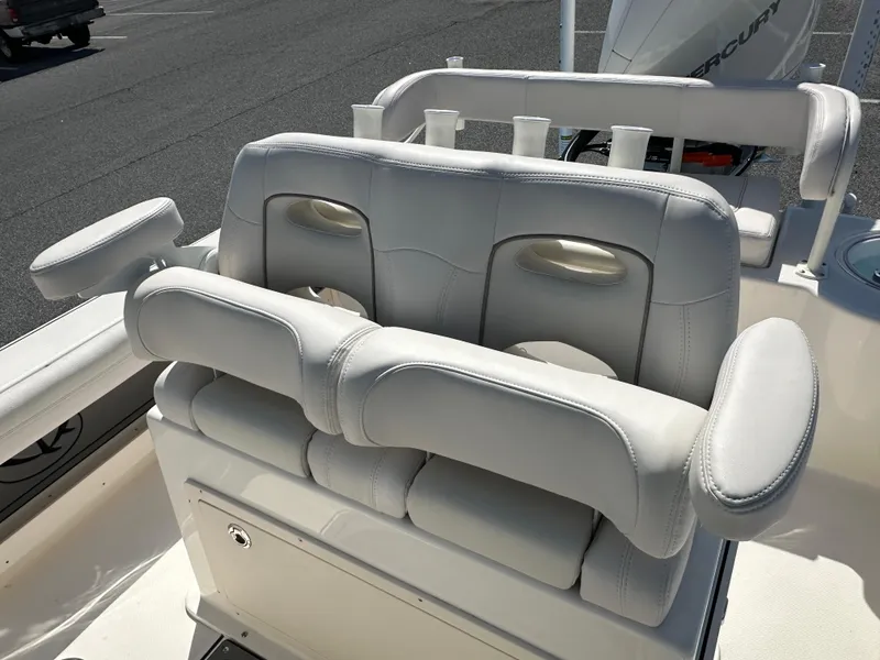 Slide: The Image of 2024 Sea Born FX25 Bay boat with cushioned seating and rod holders. - 23