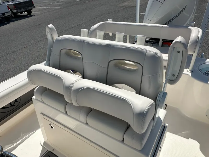Slide: The Image of 2024 Sea Born FX25 Bay boat with cushioned seating and rod holders. - 24
