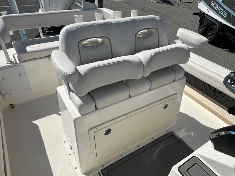 Slide: The Image of 2024 Sea Born FX25 Bay boat with cushioned seating and storage compartment. - 26