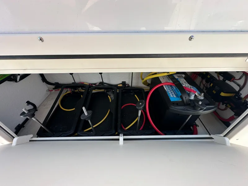 Slide: The Image of 2024 Sea Born FX25 Bay boat battery compartment with wiring. - 28