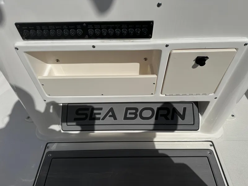 Slide: The Image of 2024 Sea Born FX25 Bay boat console with storage compartments and control panel. - 29