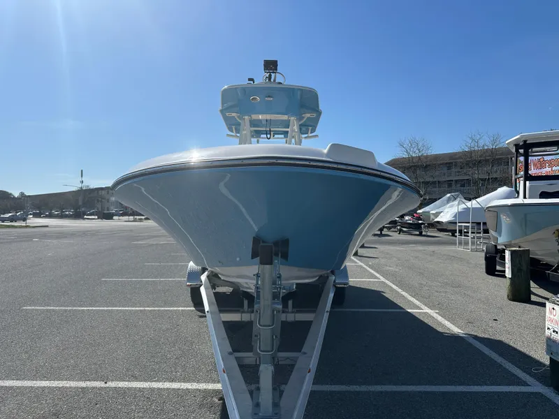 Slide: The Image of 2024 Sea Born FX25 Bay boat on a trailer in a parking lot. - 3