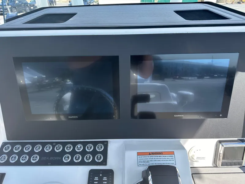 Slide: The Image of 2024 Sea Born FX25 Bay boat dashboard with dual Garmin displays. - 32