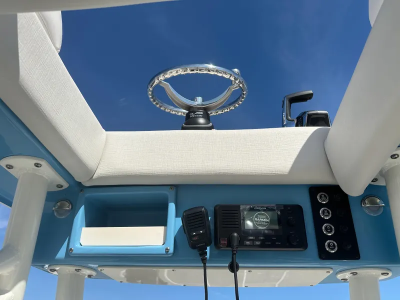 Slide: The Image of 2024 Sea Born FX25 Bay boat helm with steering wheel and control panel. - 37