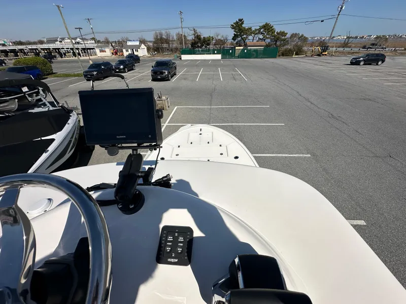 Slide: The Image of 2024 Sea Born FX25 Bay boat in a parking lot, view from the helm. - 38