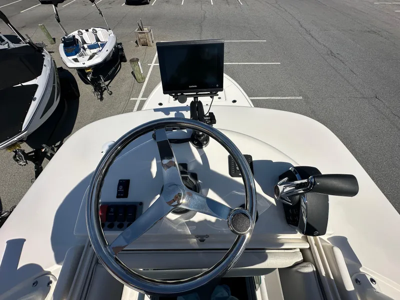 Slide: The Image of 2024 Sea Born FX25 Bay boat helm with steering wheel and navigation screen. - 39