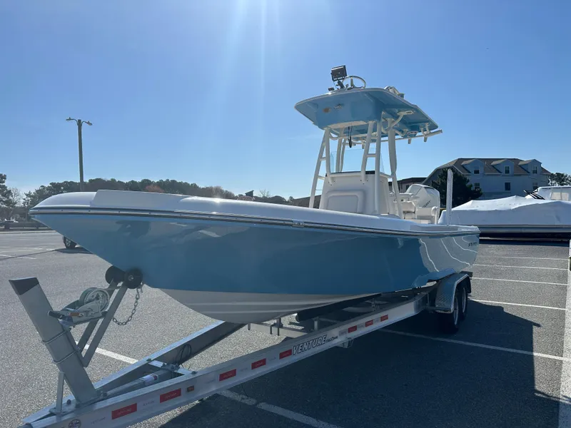 Slide: The Image of 2024 Sea Born FX25 Bay boat on a trailer in a parking lot. - 4