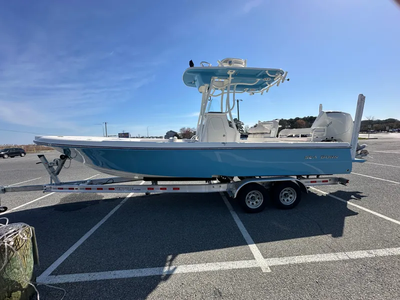 Slide: The Image of 2024 Sea Born FX25 Bay boat on a trailer in a parking lot. - 5