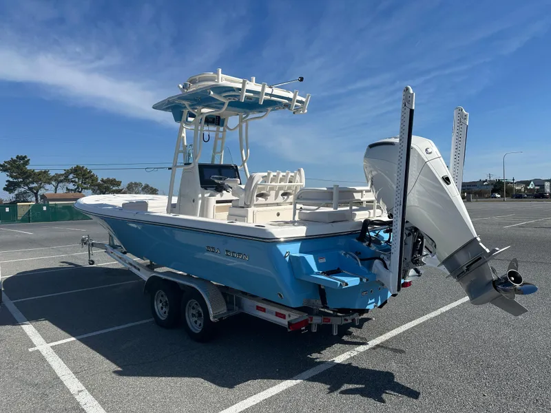Slide: The Image of 2024 Sea Born FX25 Bay boat on trailer in parking lot. - 6