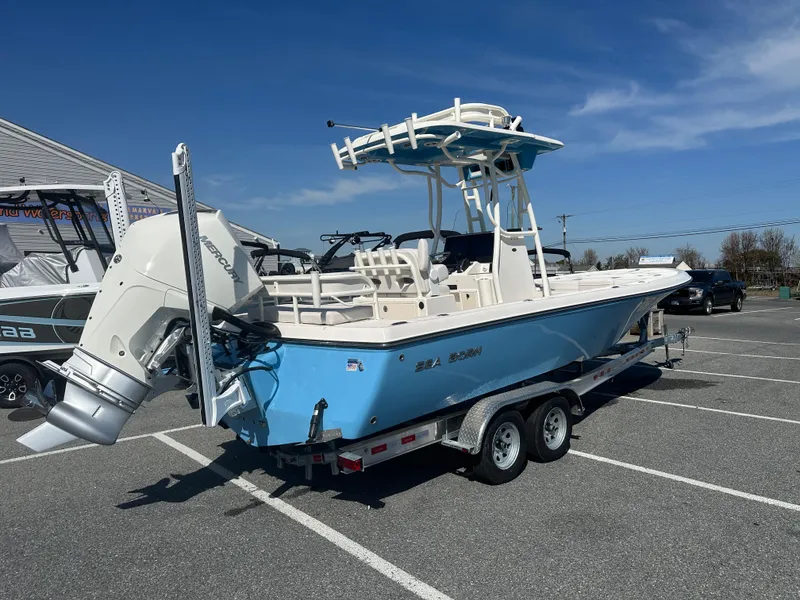 Slide: The Image of 2024 Sea Born FX25 Bay boat on a trailer in a parking lot. - 7