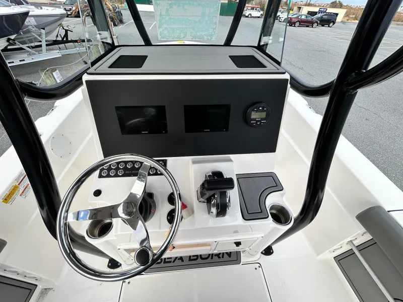 Slide: The Image of 2024 Sea Born LX 22 LE boat console with steering wheel and controls. - 12