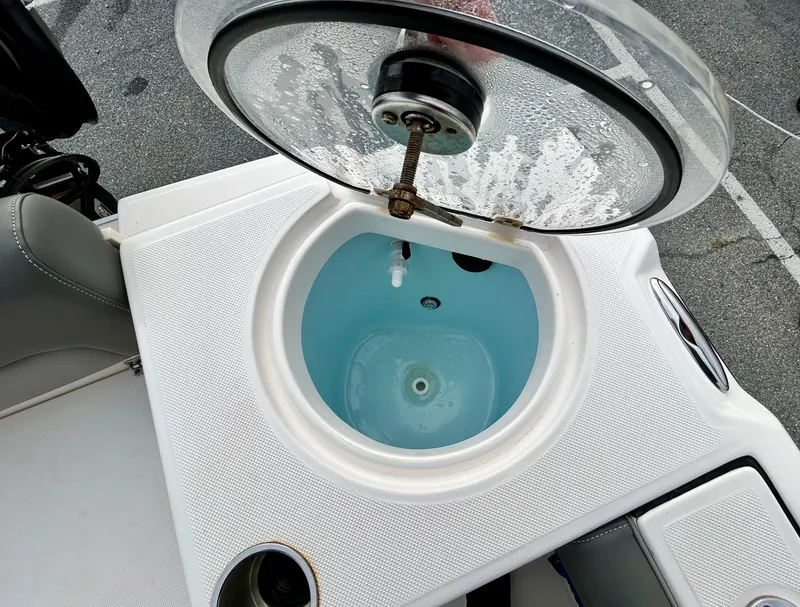 Slide: The Image of Livewell on 2024 Sea Born LX 22 LE boat, open lid, filled with water. - 14