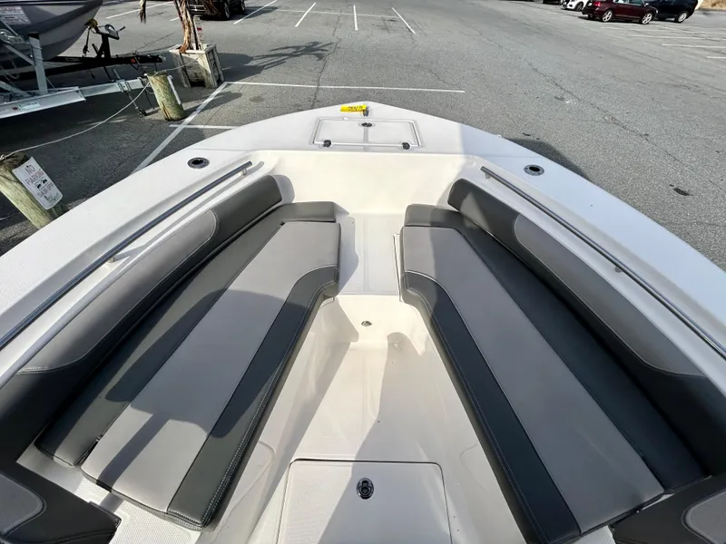 Slide: The Image of 2024 Sea Born LX 22 LE boat interior with gray seating in a parking lot. - 15