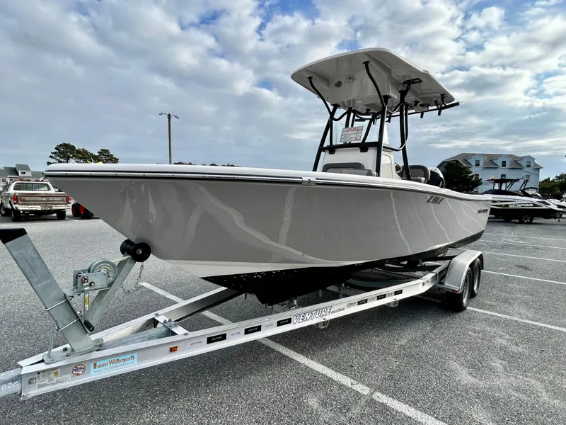Slide: The Image of 2024 Sea Born LX 22 LE boat on trailer, parked outdoors under cloudy sky. - 3