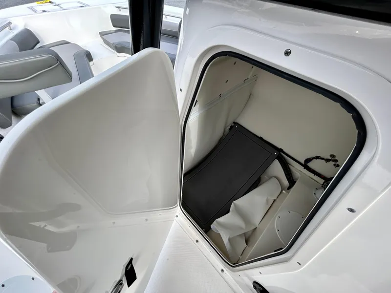 Slide: The Image of 2024 Sea Born LX 22 LE boat storage compartment with open door. - 7