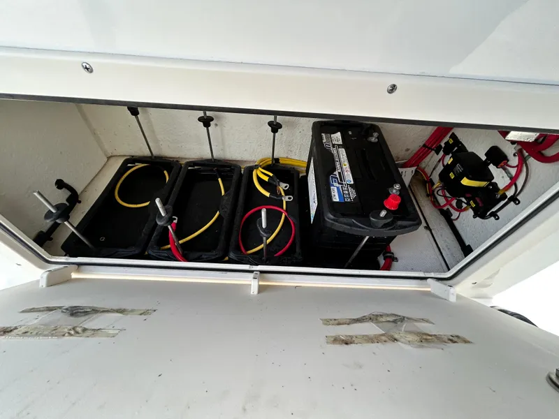 Slide: The Image of 2024 Sea Born LX 22 LE boat battery compartment with wiring and connections. - 8