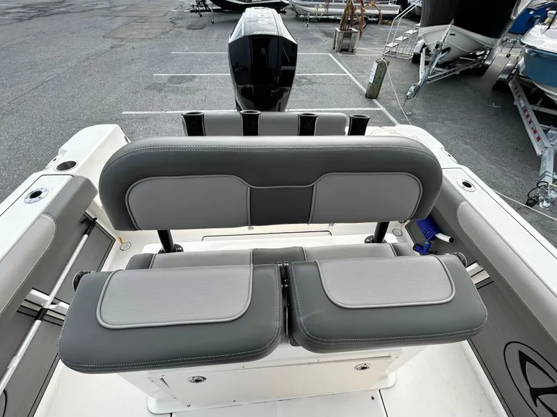 Slide: The Image of 2024 Sea Born LX 22 LE boat seating with gray upholstery in a parking lot. - 9