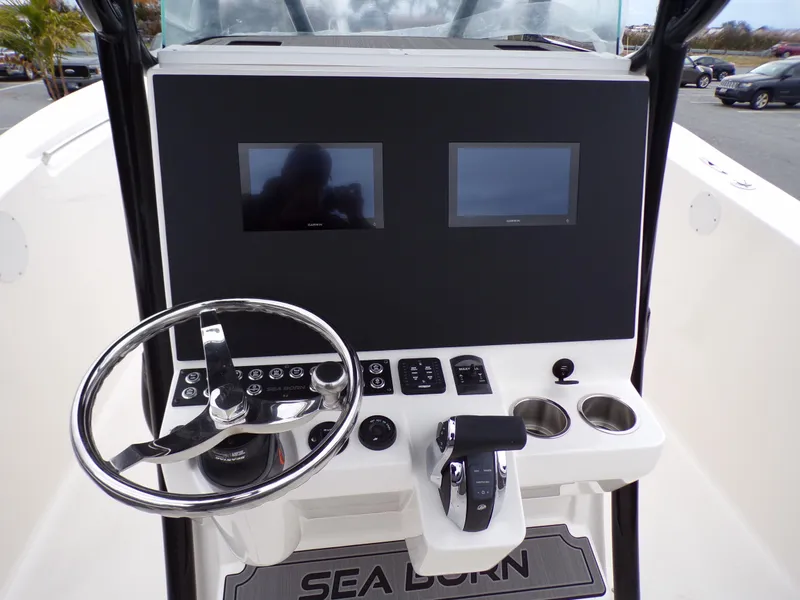 Slide: The Image of 2024 Sea Born SX 239 boat dashboard with dual screens and steering wheel. - 12