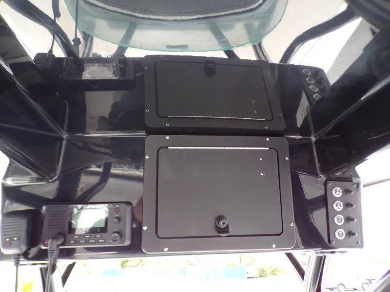 Slide: The Image of 2024 Sea Born SX 239 boat console with storage compartments and electronic controls. - 13