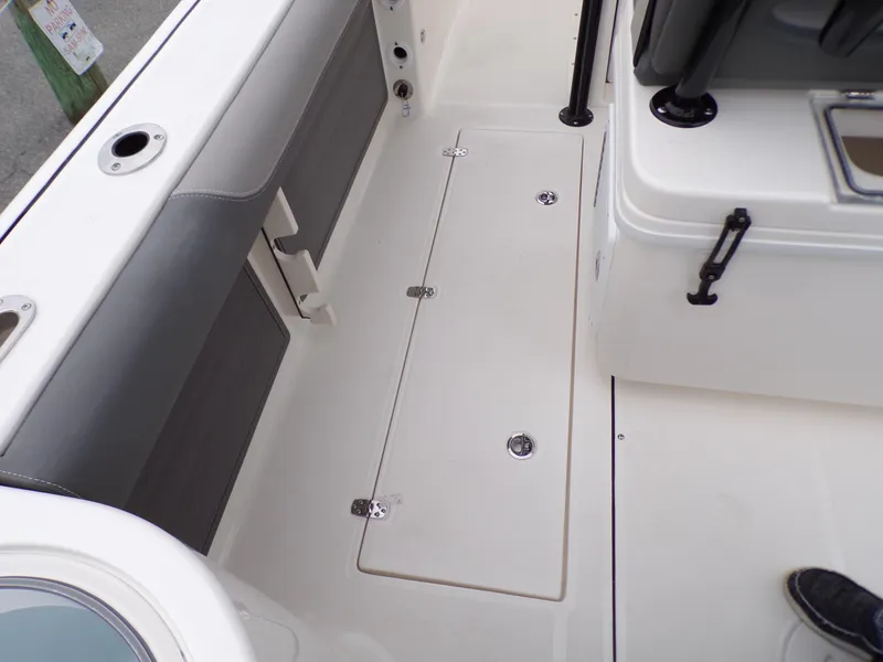 Slide: The Image of 2024 Sea Born SX 239 boat interior deck with storage compartments. - 19
