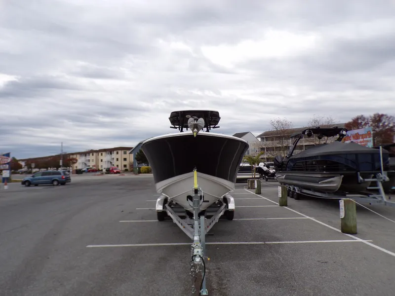 Slide: The Image of 2024 Sea Born SX 239 boat on a trailer in a parking lot. - 3