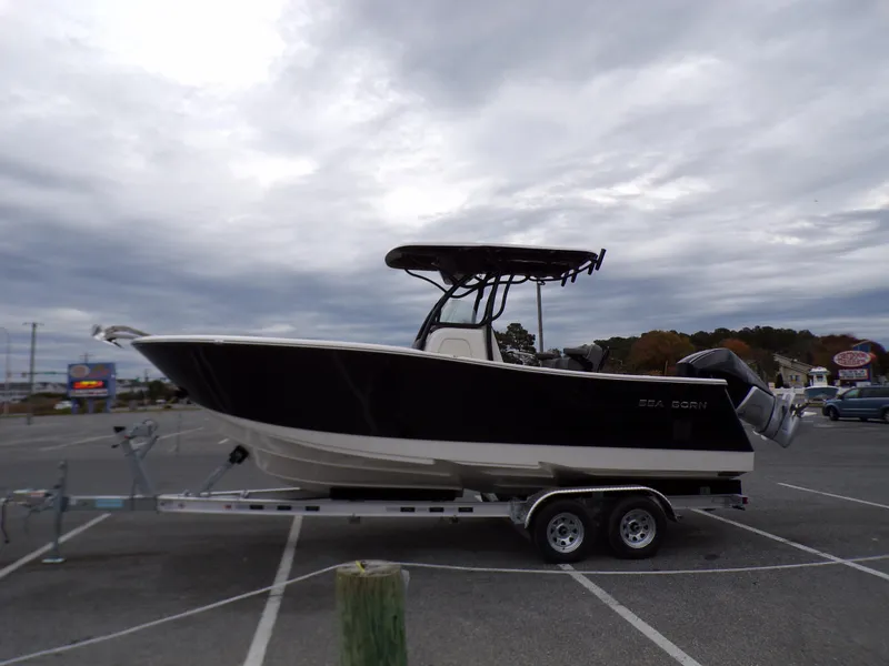 Slide: The Image of 2024 Sea Born SX 239 boat on a trailer in a parking lot. - 5