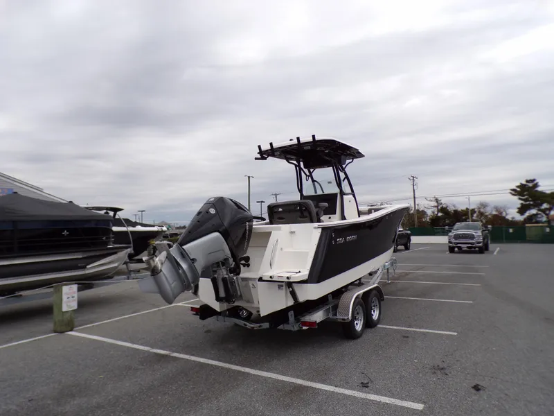 Slide: The Image of 2024 Sea Born SX 239 boat on a trailer in a parking lot. - 7