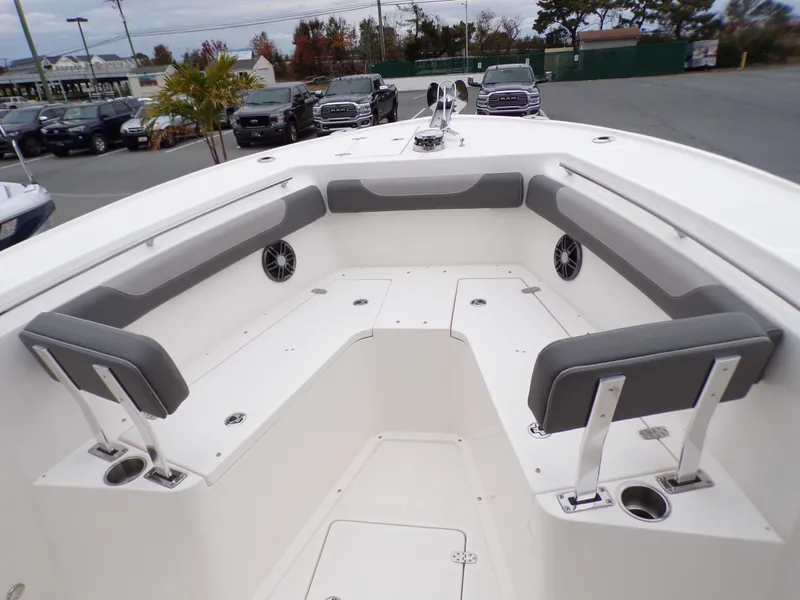 Slide: The Image of 2024 Sea Born SX 239 boat interior with cushioned seating and cup holders. - 8