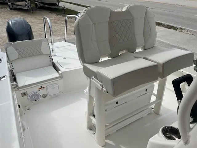 Slide: The Image of 2024 World Cat 235 CC boat interior with cushioned seating and control panel. - 5