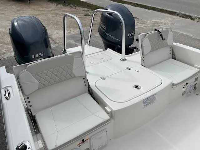 Slide: The Image of 2024 World Cat 235 CC boat with twin Yamaha 115 engines and cushioned seating. - 6