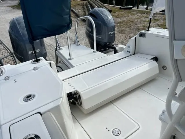 Slide: The Image of 2024 World Cat 260 CC-X boat with dual 200 HP engines, rear seating, and spacious deck. - 7