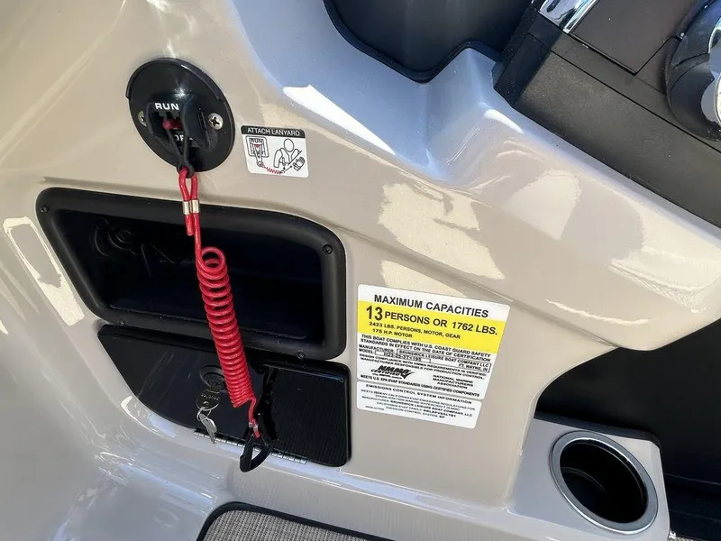 Slide: The Image of 2024 Harris Cruiser 230 dashboard with safety features and capacity label. - 11