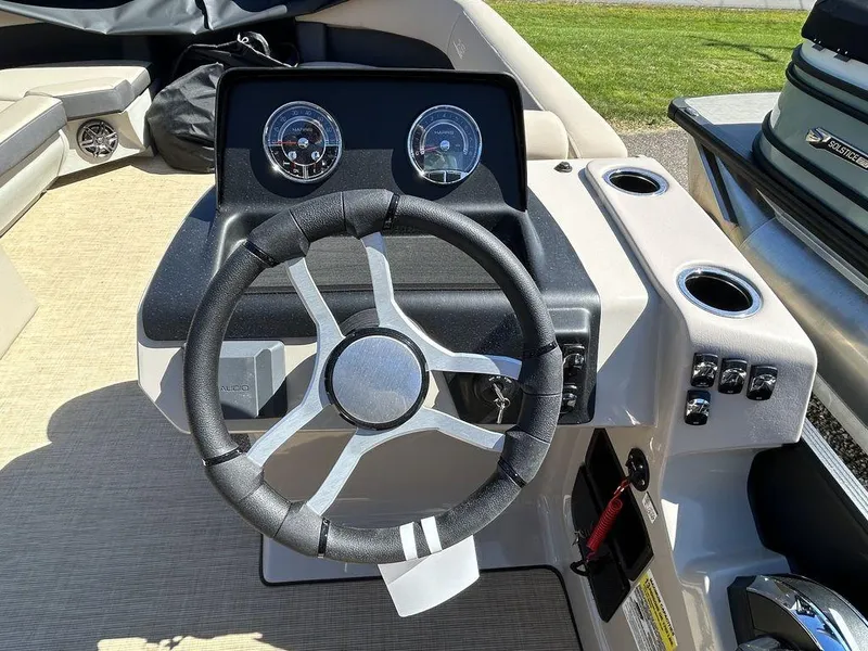 Slide: The Image of 2024 Harris Cruiser 230 steering console with gauges and controls. - 15