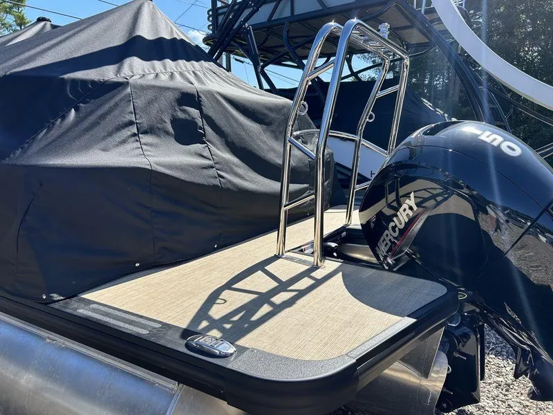 Slide: The Image of 2024 Harris Cruiser 230 boat with Mercury engine and covered deck. - 5