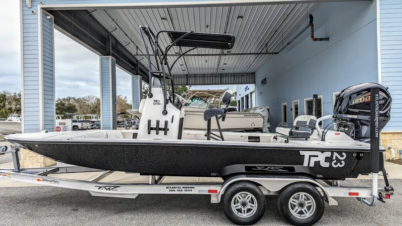 Slide: The Image of 2024 Tidewater 23 TPC Raptor boat on trailer in a covered area. - 0