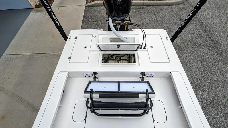 Slide: The Image of 2024 Tidewater 23 TPC Raptor boat deck with storage compartments and motor. - 10