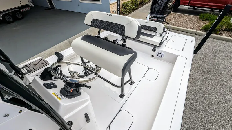 Slide: The Image of 2024 Tidewater 23 TPC Raptor boat interior with steering wheel and seating. - 12