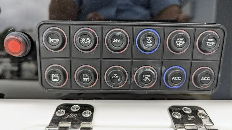 Slide: The Image of Control panel of 2024 Tidewater 23 TPC Raptor boat with various function buttons. - 13