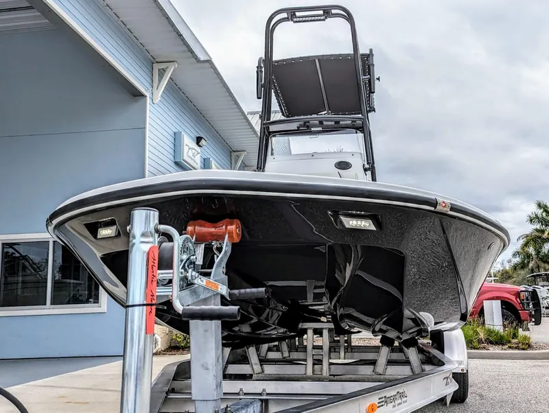 Slide: The Image of 2024 Tidewater 23 TPC Raptor boat on trailer, front view, near building. - 4