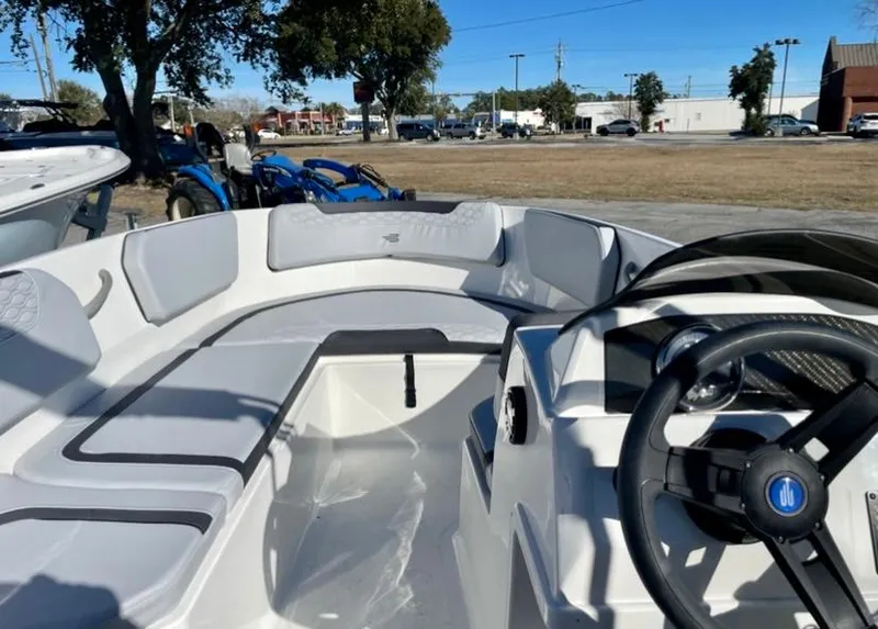 Slide: The Image of 2024 Bayliner Element M15 boat interior with seating and steering wheel. - 8