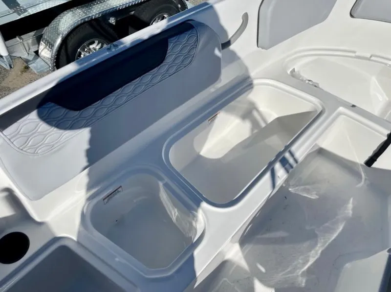 Slide: The Image of 2024 Bayliner Element M15 boat interior storage compartments and seating area. - 10