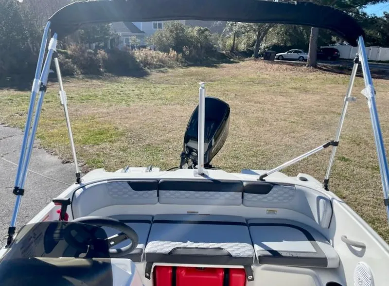 Slide: The Image of 2024 Bayliner Element M15 boat interior with bimini top and outboard motor. - 4