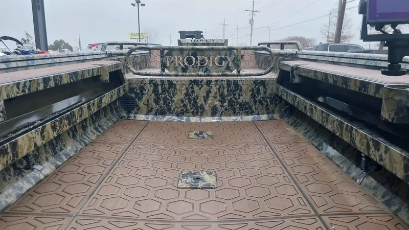 Slide: The Image of 2022 Prodigy 18x60 Marsh Tuff boat interior with camouflage design and spacious deck. - 2