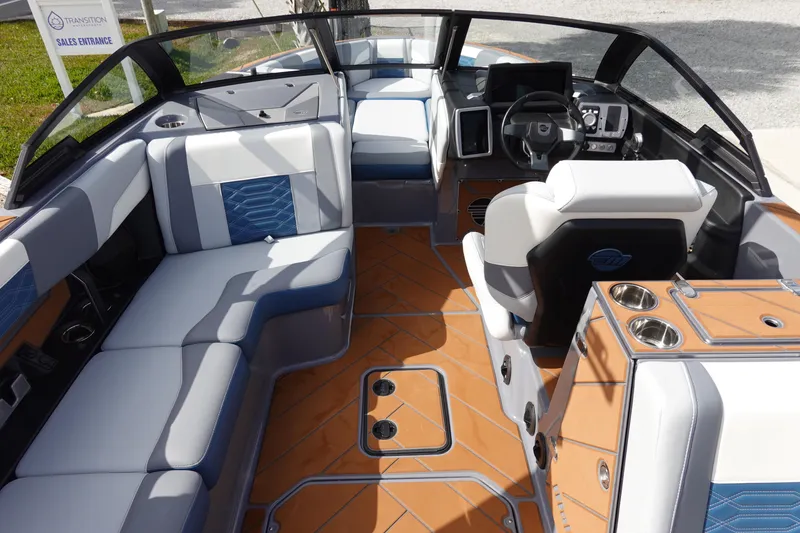Slide: The Image of 2023 Malibu 25 LSV boat interior with luxurious seating and modern dashboard. - 13