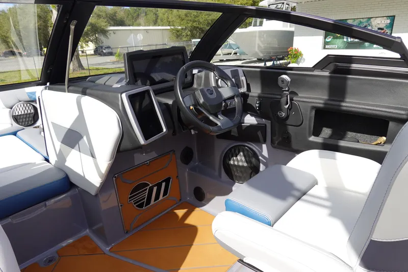 Slide: The Image of 2023 Malibu 25 LSV boat interior with modern dashboard and comfortable seating. - 14