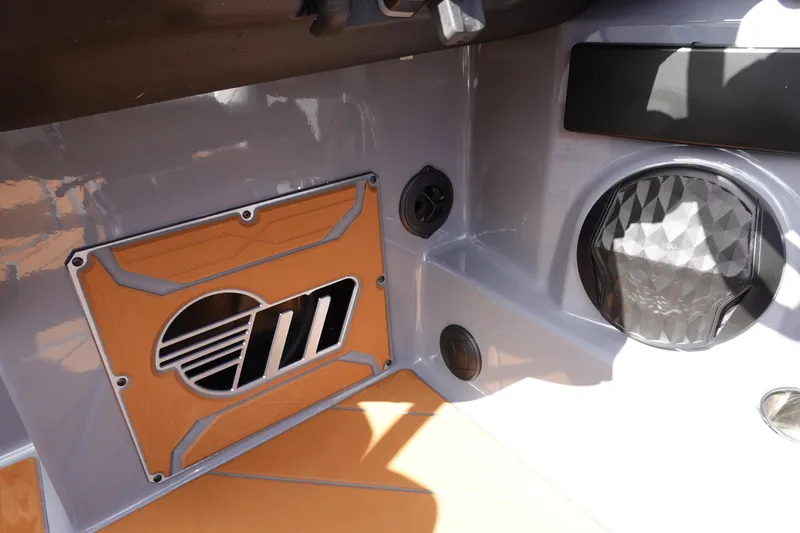 Slide: The Image of 2023 Malibu 25 LSV boat interior with speaker and logo detail. - 17