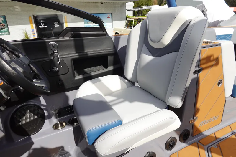 Slide: The Image of 2023 Malibu 25 LSV boat interior with captain's seat and dashboard. - 18